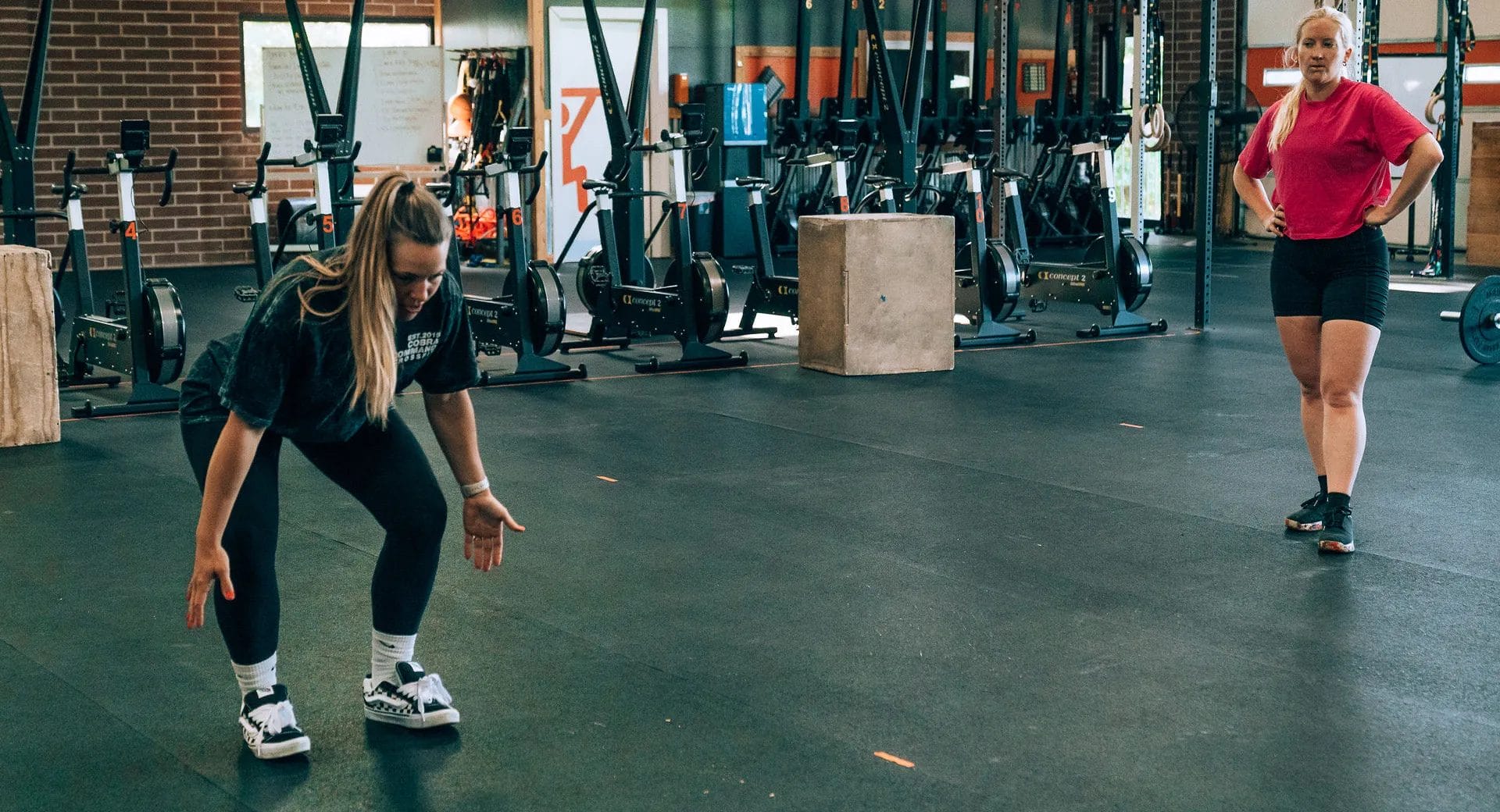Female trainer showing an exercise to a woman